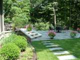 Walkway leading to patio and terrace designed by landscape architect.